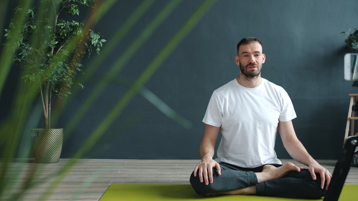 Man in warrior pose practicing strength yoga